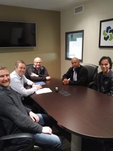Representatives from Sherwin Williams meet with training staff from the FTI to sign a new three sponsorship agreement.