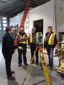 from the right, Liberal MP John Aldag, DC 38 BM/ST Dave Holmes and Tom Sigurdson E.D. of the BC Building Trades listen as FTI Glazing Instructor Mark Longmore demonstrates some of the equipment used in the Glazier Apprenticeship program.